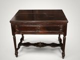 an old wooden table with a drawer on top of it