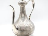 an antique silver teapot on a white background with a white background