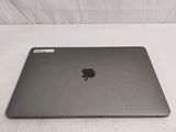 a black apple laptop sitting on a white surface