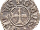 a silver coin with a cross on it