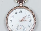 an antique pocket watch with a white face and gold hands