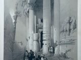 an old picture of a group of people sitting in front of a building