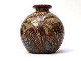 a vase that is sitting on a white surface