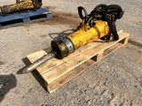 a yellow fire hydrant sitting on a pallet in the dirt