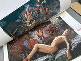 a picture of a woman laying on a surfboard in a magazine