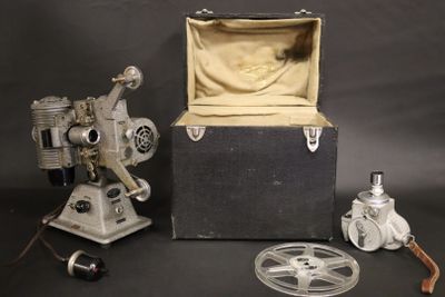 an old movie projector and other items on a black background