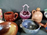 many different types of vases and bowls on the table