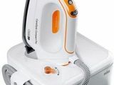 a white and orange steam iron sitting on top of a box