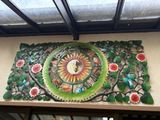 une horloge sur la façade d'un immeuble, ornée de fleurs