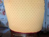 a chair that is sitting in a room with a wallpapered wall
