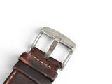 leather watch strap with a buckle on a white background