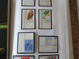 an open book with stamps on it on a table