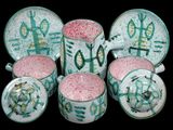 a group of cups and saucers with designs on them