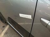 a sticker on the door of a silver car