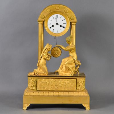 a gold clock that is sitting on top of a table
