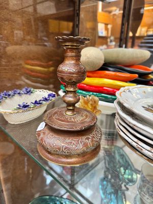 a glass shelf with plates and bowls on it