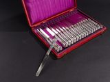 a red case with silverware in it on a black surface