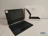 an open laptop computer sitting on top of a table next to a box