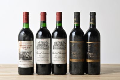 four bottles of wine are lined up on a wooden table