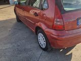 an image of a red car parked in front of a garage