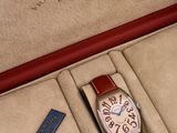 a watch in a red box with a blue cord