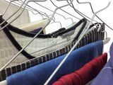 a lot of clothes hanging on a rack in a closet