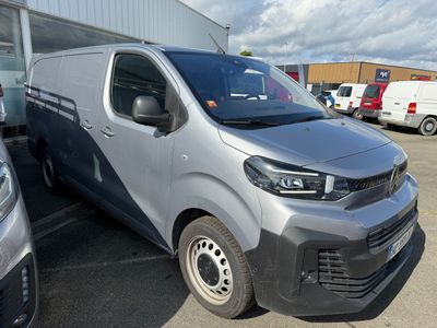 a silver van that is parked in a parking lot