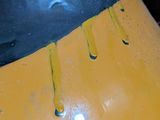 a close up of a yellow vase with yellow paint on it