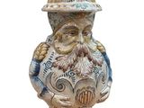 a ceramic figurine of a man with a hat and beard
