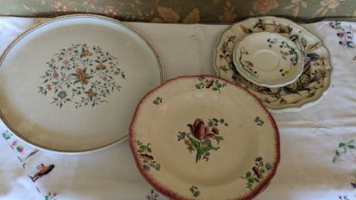 two plates and a bowl sitting on a table