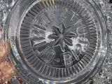 a glass vase with a clock inside of it on a table