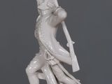 a statue of a man holding a sword on a table