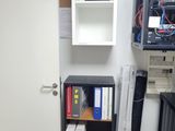 a room with a cabinet and a computer on the wall