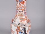 a vase that has a picture of a woman on it