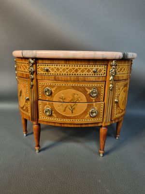 an image of a small chest of drawers with a marble top