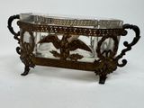 a glass bowl with an eagle on it on a stand