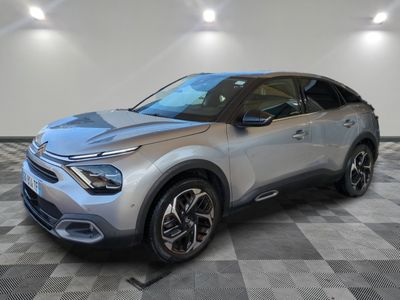 a silver car is parked in a room with a checkered floor