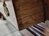 a wooden dresser with a drawer on top of it