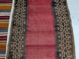 two rugs with different colors and patterns on them on a floor