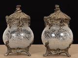 pair of antique silver plated vases on stand on table