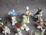 many figurines of birds that are sitting on a table
