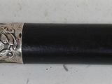 a black pipe with a silver ring on it