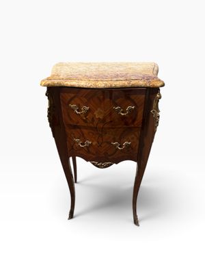 an antique chest of drawers with marble top