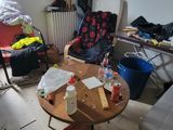 a room with a lot of clutter and furniture in it