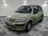 a picture of a small green car parked in a garage