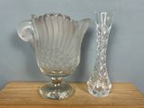 a glass vase and a glass vase on a wooden table