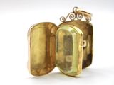 a gold ring with a locke inside of it