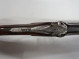 a close up of a rifle on a white surface