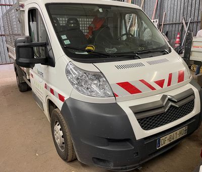 a white van with red stripes parked in a garage