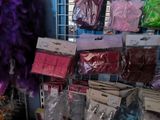 many bags of different colors and sizes on the shelf